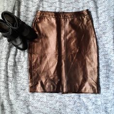 Hugo Buscati Genuine Leather Pencil Skirt Beautiful Metallic Rose Gold, Bronze Color Size: 4 Measurements Laid Flat Across Front: Waist: 14" Hips: 17 3/4" Material: Genuine Leather Outer Fully Lined New Old Stock Item. Catalog Return/Overstock Purchased At An Event Sale Columbus, Ohio. Tags May Be Removed Or Marked As Is Required By Some Manufacturers As A Condition Of Resale.