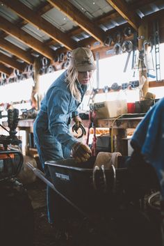 a woman working in a workshop with tools