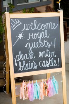 a welcome sign with tassels hanging from it