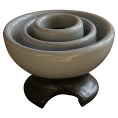 three gray and white bowls sitting on top of each other