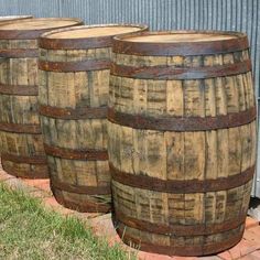 several wooden barrels lined up in front of a building