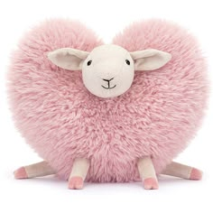 a pink sheep stuffed animal sitting on top of a white floor