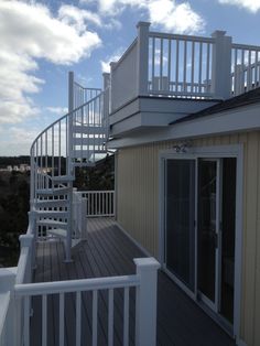 there is a white stair case on the deck