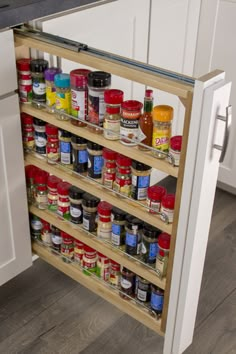 an organized spice rack in the middle of a kitchen