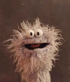 a close up of a stuffed animal with big eyes