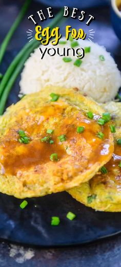 an egg omelet on a plate with rice and green onions next to it