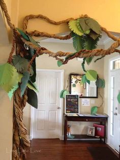 a hallway decorated with paper leaves and branches