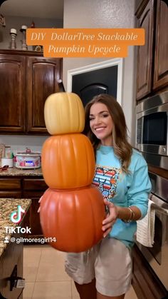 a woman standing next to a pumpkin stacked on top of each other with the words diy dollartree stackable pumpkin upside down