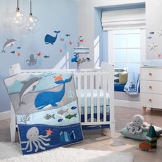 a baby's room decorated in blue and white