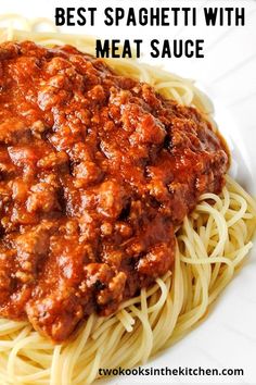 a white plate topped with spaghetti and meat sauce