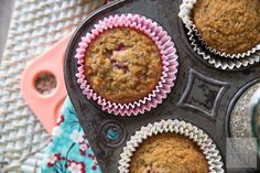 four muffins in a cupcake tin on a table