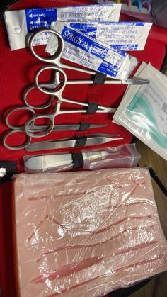 scissors and other medical supplies in a red case