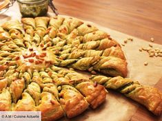 there is a pastry on the cutting board with nuts around it and another pie in the background