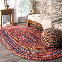 a colorful rug is on the floor next to a bed