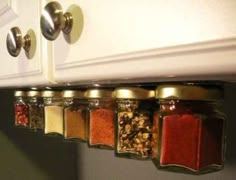 an image of spice rack in the kitchen with spices hanging from it's sides