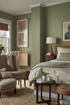 a bed sitting in a bedroom next to a chair and table on top of a rug