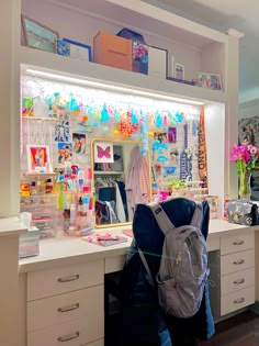 a back pack sitting on top of a counter next to a mirror and desk with drawers