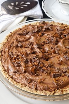 there is a pie with chocolate frosting on it