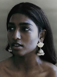 a woman with large earrings on her face