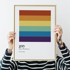 a person holding up a framed poster with gay pride on it's front and side