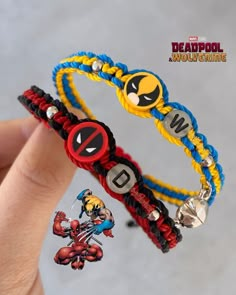 two bracelets that have different designs on them, one with the word deadpool