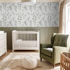 a baby's room with a crib, chair and dresser