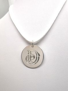 This Sterling Silver pendant measures approximately 20mm in diameter and can be personalised with a decorative initial of your choice which will be hand engraved by us in our South Yorkshire studio. The Pendant comes fitted with a Sterling Silver 5mm jump ring . The jump ring has a wire diameter of approximately 0.70mm and is left unsoldered so they can be added to a bracelet or necklace. The Pendant has been hand finished to a very high standard.  It does not carry a  British hallmark. UK Law states that silver items under the weight of 7.8grams do not have to be hallmarked. We also feel that adding a hallmark distracts from the charm pendant itself and this also keeps costs down. The Sterling Silver Vintage style Pendant comes beautifully presented in one of our own Lockley & Ashmore bra Sterling Silver Monogram Round Disc Jewelry, Silver Monogram Medallion Necklace, Silver Medallion Necklace With Monogram, Sterling Silver Initials Medallion Jewelry, Sterling Silver Medallion Jewelry With Initials, Silver Jewelry With Initials In Round Shape, Silver Jewelry With Initials, White Gold Initial Pendant With Engraving Option, Silver Medallion Initial Necklace