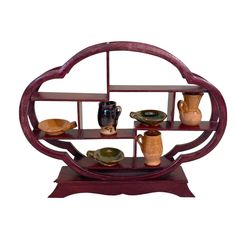 a wooden shelf with vases and plates on it's sides, in the shape of a circle