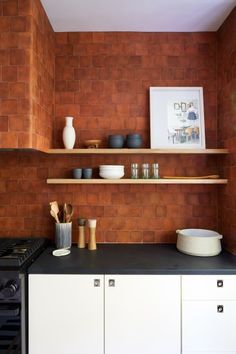 the kitchen counter is clean and ready to be used for cooking or baking, as well as dishes on shelves