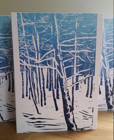 two cards with trees in the snow on them