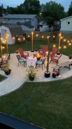 a patio with chairs and lights in the middle is lit up by string lights that are strung across the lawn