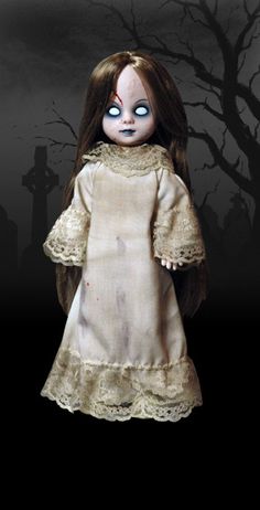 a creepy doll with blue eyes standing in front of a tree