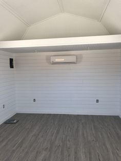 an empty room with white walls and wood flooring is shown in the foreground