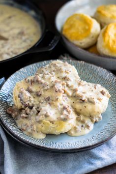 biscuits and gravy on a plate next to other foods