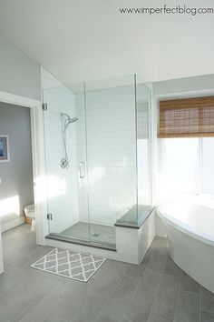 a bathroom with a tub, toilet and shower in it's own area is shown