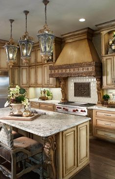 a large kitchen with an island in the middle and lots of lights hanging from the ceiling