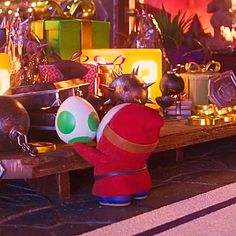 a nintendo figurine is standing in front of a table full of christmas decorations