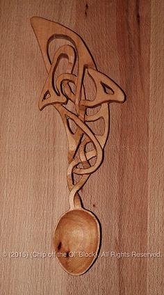 a wooden spoon with an intricate design on it