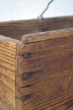 an old wooden box sitting on top of a white sheet covered ground with no one around it