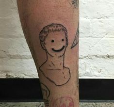 a man's leg with a drawing of himself on it