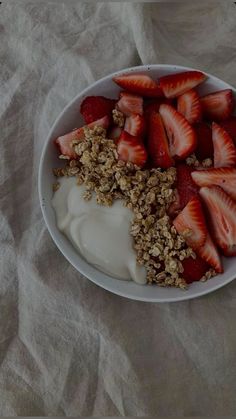 strawberries and yogurt are arranged in a bowl