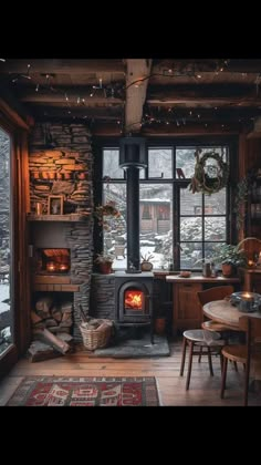 a living room filled with furniture and a fire place next to a large glass window