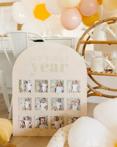 a baby's first year photo frame surrounded by balloons