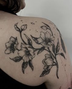 a woman's shoulder with flowers on it