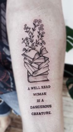 Beautiful Book Tattoo Idea Book Flower Butterfly Tattoo, Book Flower Tattoo Ideas, Book Quotes Tattoos For Women, Bookish Spine Tattoos For Women, Daydream Tattoo Ideas, Black And White Book Tattoo, Book Flash Tattoo, Book Spine Tattoo, Book Reader Tattoo Ideas