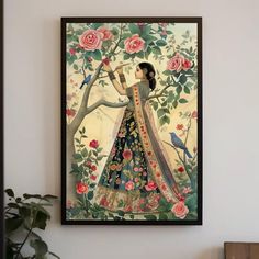 a painting hanging on the wall next to a potted plant and vase filled with flowers