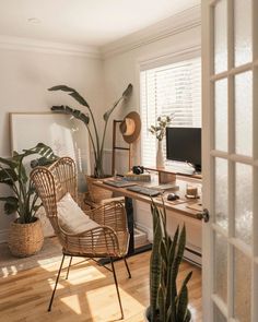 an instagram photo of a living room with plants on the table and a chair