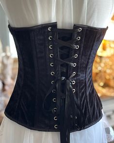 Transform your look with the Bious Corset. Made with luxurious black velvet, this overbust corset will enhance your curves and give you a confident, alluring silhouette. Elevate your style and make heads turn with this must-have fashion staple. The Bious Corset Gorgeous Black Velvet Over Bust Corset. Velvet lined with cotton and steel boned. Front metal busk Opening and back lacing with white satin ribbon. The center front length is 14.5" and back length 13".New colors added Black satin.Sizes X- Over Bust Corset, Overbust Corset, Black Corset, White Satin, Corsets, Guinea Bissau, British Indian, Satin Ribbon, Black Satin