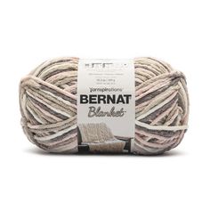 bernat blanket yarn in beige and white, on a white background with the label