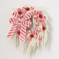 a red and white wreath with ornaments on it